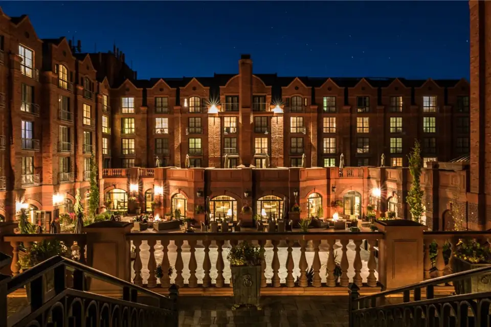 An illuminated hotel courtyard at dusk